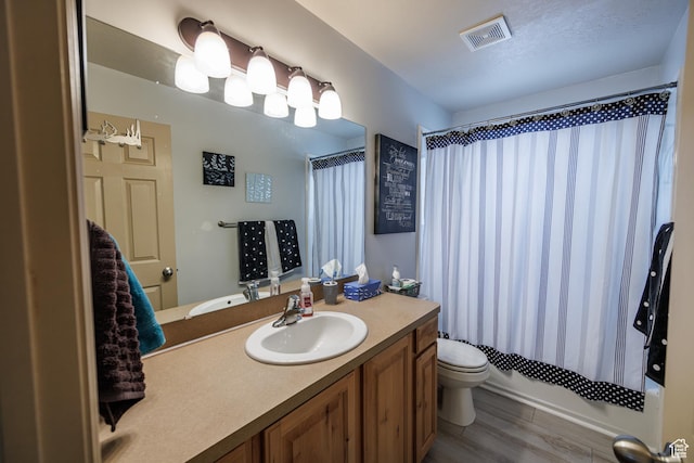 680 Stonne Ln, Kaysville, UT 84037 - bathroom featuring visible vents, wood finished floors, vanity, toilet, and shower / tub combo with curtain