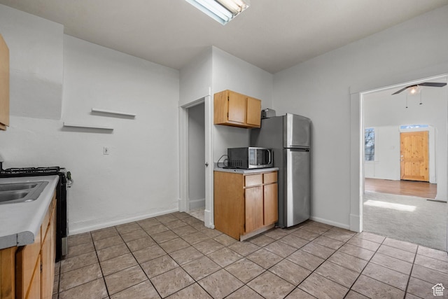 779 S 400 E, Salt Lake City, UT 84111 - kitchen featuring light tile patterned flooring, baseboards, ceiling fan, light countertops, and stainless steel appliances