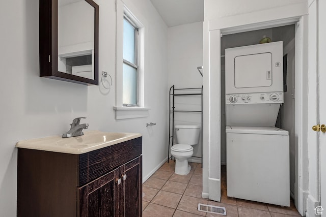 779 S 400 E, Salt Lake City, UT 84111 - bathroom featuring visible vents, vanity, toilet, stacked washing maching and dryer, and tile patterned floors