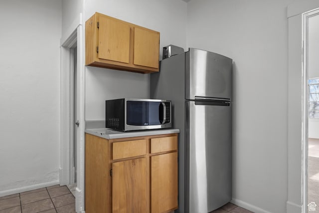779 S 400 E, Salt Lake City, UT 84111 - kitchen with light countertops, baseboards, appliances with stainless steel finishes, and light tile patterned floors