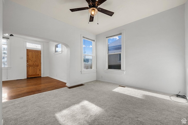 779 S 400 E, Salt Lake City, UT 84111 - interior space with carpet flooring, arched walkways, ceiling fan, and a healthy amount of sunlight