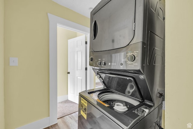 3485 S Grant Ave, Ogden, UT 84403 - clothes washing area with baseboards, laundry area, wood finished floors, and stacked washer and clothes dryer