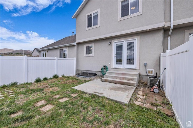 3909 N Davencourt Loop, Lehi, UT 84043 - back of house with central air condition unit, a fenced backyard, a yard, entry steps, and stucco siding