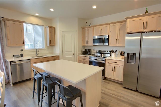 200 W 1200 S Unit 61, Tremonton, UT 84337 - kitchen featuring a sink, light countertops, light brown cabinets, a breakfast bar, and stainless steel appliances