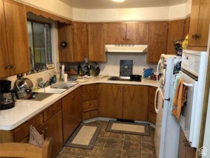98 W 600 N, Logan, UT 84321 - kitchen featuring light countertops, under cabinet range hood, brown cabinets, and white appliances