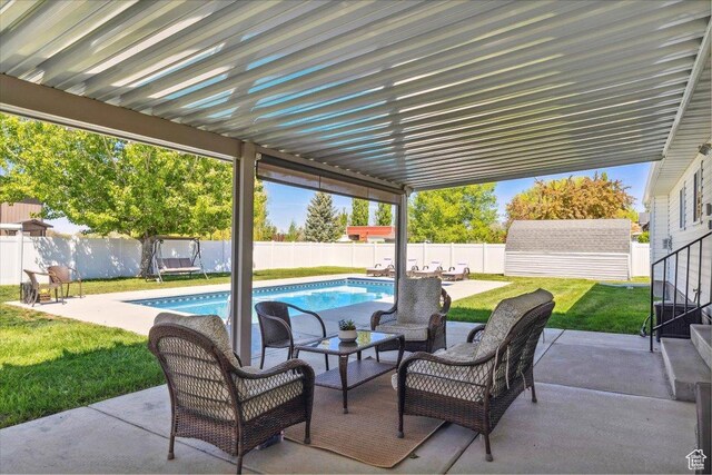121 N 3000 W, West Point, UT 84015 - view of patio with outdoor lounge area, an outbuilding, a fenced backyard, and a fenced in pool