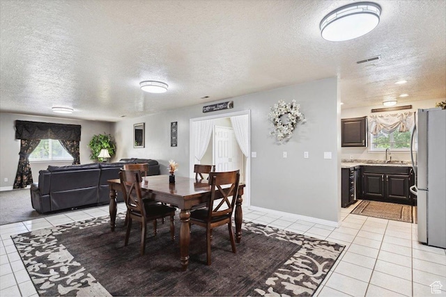 121 N 3000 W, West Point, UT 84015 - dining room featuring light tile patterned flooring, a textured ceiling, visible vents, and baseboards