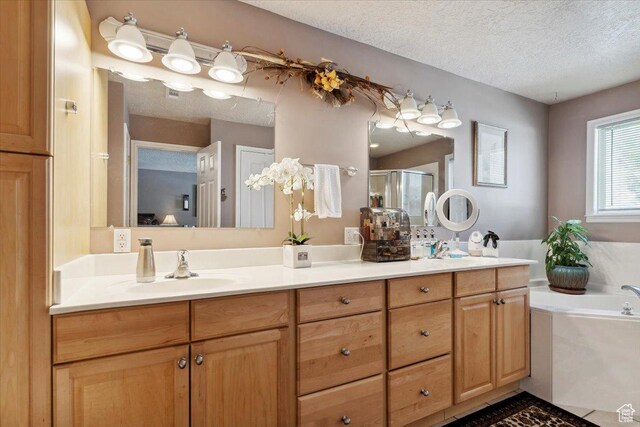 121 N 3000 W, West Point, UT 84015 - full bathroom with double vanity, a bath, a textured ceiling, a shower stall, and a sink