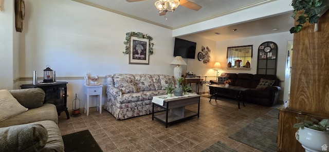 living area featuring crown molding and a ceiling fan