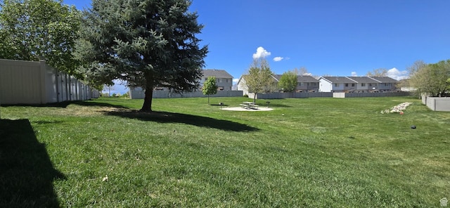 view of yard featuring fence and a residential view
