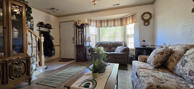 living room featuring visible vents and ornamental molding