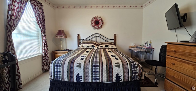bedroom with baseboards and carpet