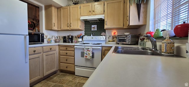 kitchen featuring a sink, white appliances, light countertops, a toaster, and under cabinet range hood