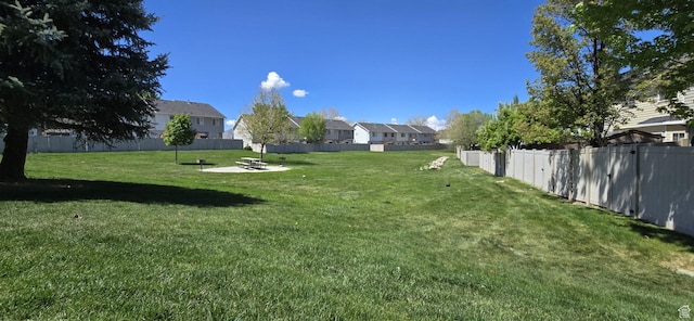 view of yard featuring fence and a residential view
