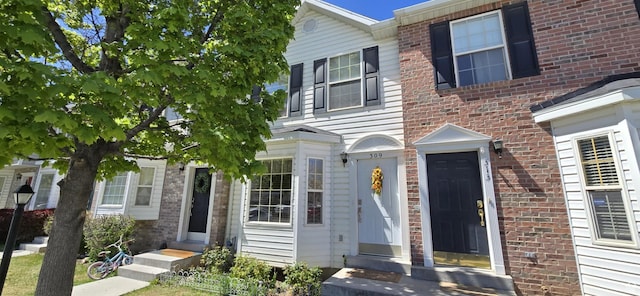 multi unit property featuring brick siding and entry steps