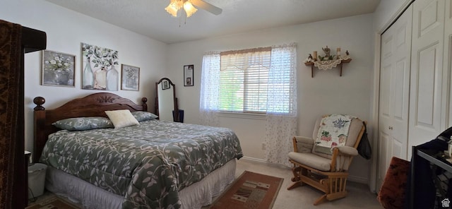 carpeted bedroom featuring a closet and ceiling fan