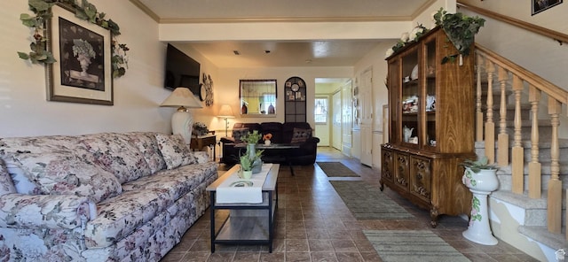 living room featuring crown molding and stairway