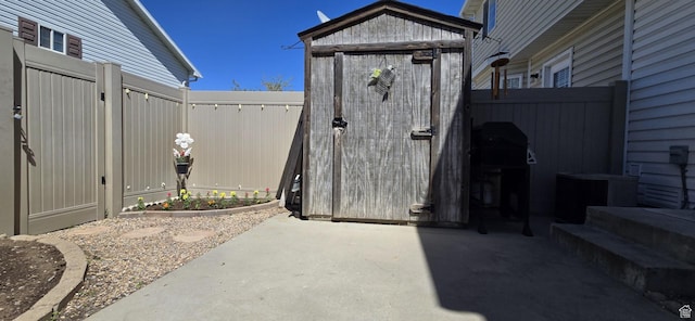 view of shed featuring fence