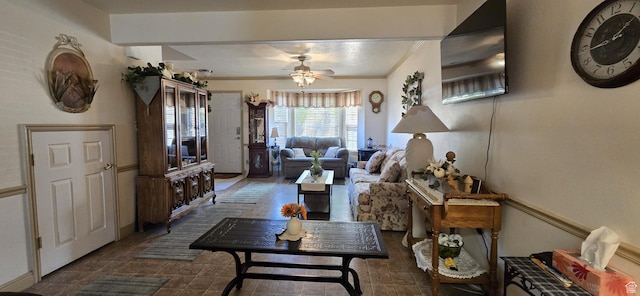 living room with crown molding and ceiling fan
