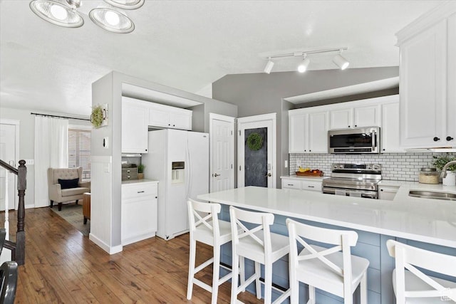 1090 N 3450 W, Layton, UT 84041 - kitchen with decorative backsplash, a peninsula, light countertops, a sink, and stainless steel appliances