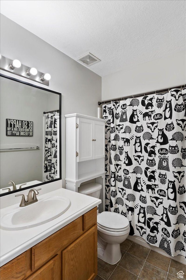 1090 N 3450 W, Layton, UT 84041 - bathroom with a textured ceiling, visible vents, tile patterned flooring, vanity, and toilet