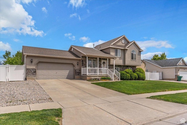 1090 N 3450 W, Layton, UT 84041 - tri-level home with a gate, an attached garage, stucco siding, and stone siding