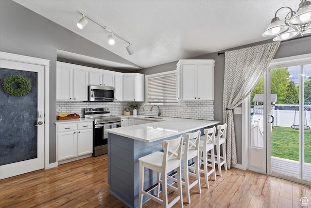 1090 N 3450 W, Layton, UT 84041 - kitchen with a sink, appliances with stainless steel finishes, white cabinets, and lofted ceiling