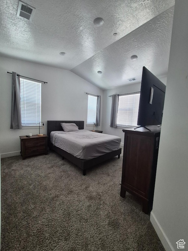 carpeted bedroom featuring a textured ceiling, baseboards, visible vents, and lofted ceiling