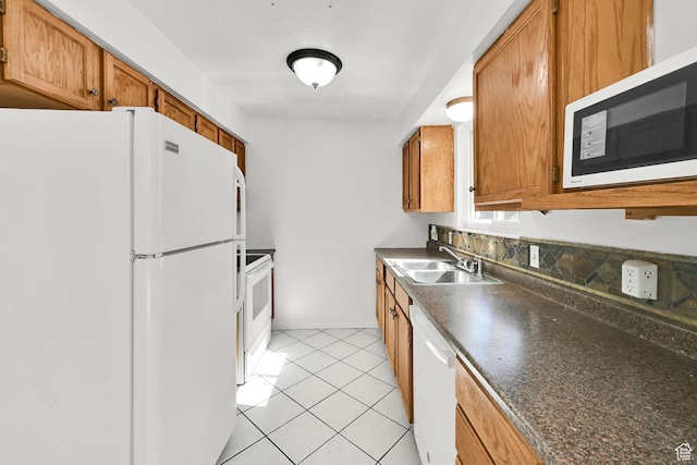 4522 S 2675 W, Roy, UT 84067 - kitchen with brown cabinetry, a sink, dark countertops, and white appliances