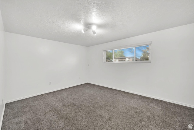 4522 S 2675 W, Roy, UT 84067 - unfurnished room featuring baseboards, dark colored carpet, and a textured ceiling