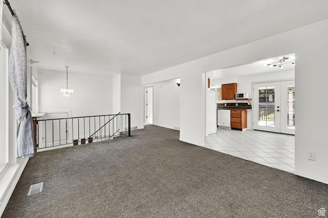 4522 S 2675 W, Roy, UT 84067 - spare room featuring visible vents, light colored carpet, light tile patterned floors, baseboards, and a chandelier