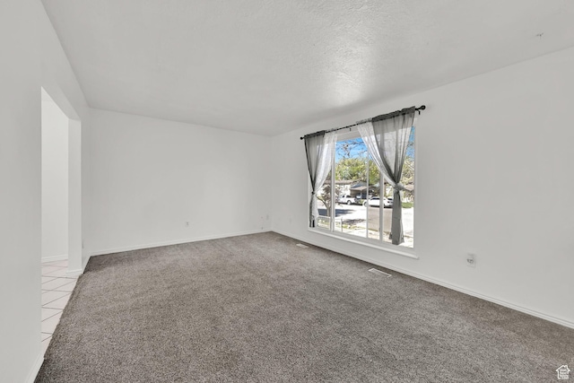 4522 S 2675 W, Roy, UT 84067 - spare room featuring baseboards, tile patterned flooring, carpet, and a textured ceiling