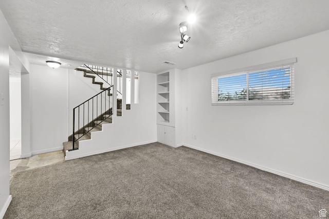 4522 S 2675 W, Roy, UT 84067 - spare room with carpet floors, baseboards, stairway, a textured ceiling, and built in shelves