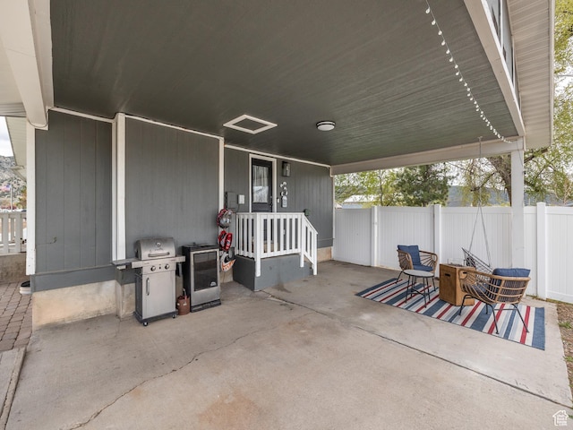 view of patio / terrace featuring fence and a grill