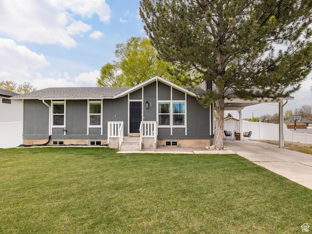 mid-century inspired home with a front lawn, fence, and concrete driveway
