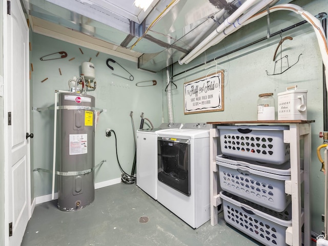 clothes washing area with secured water heater, laundry area, baseboards, and washer and dryer