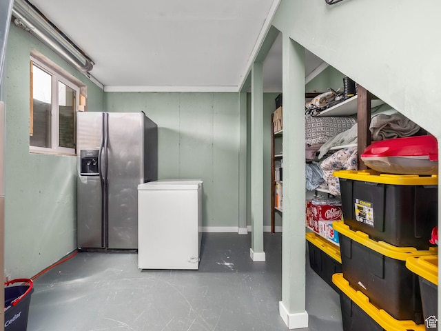interior space with stainless steel fridge, baseboards, and fridge