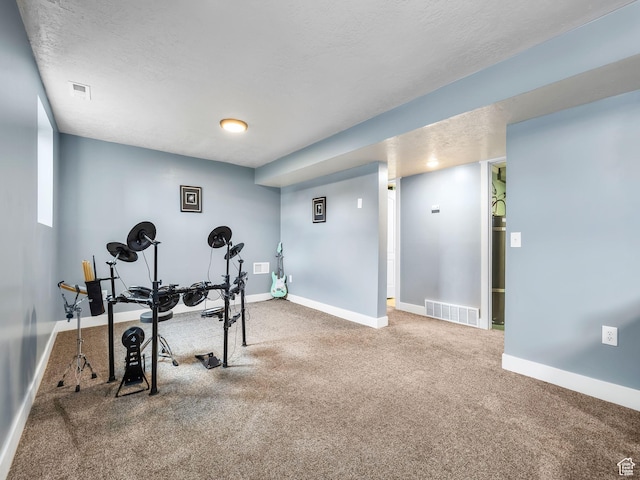 workout room with baseboards, carpet, and visible vents