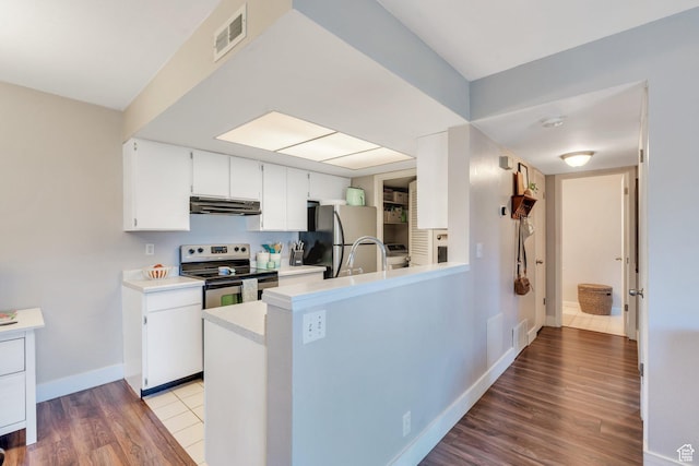 1275 E Shadow Ridge Dr S Unit 10N, Cottonwood Heights, UT 84047 - kitchen with appliances with stainless steel finishes, light countertops, wood finished floors, under cabinet range hood, and visible vents