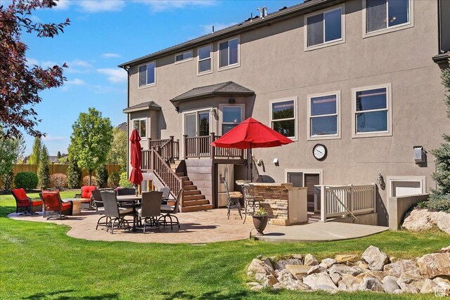 864 S Wellington Dr W, Kaysville, UT 84037 - back of house featuring stairway, a patio, a yard, and stucco siding