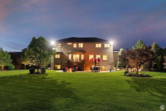 864 S Wellington Dr W, Kaysville, UT 84037 - back of house with a lawn, a patio, and stucco siding