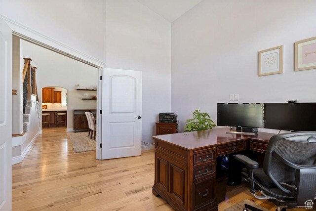864 S Wellington Dr W, Kaysville, UT 84037 - home office featuring high vaulted ceiling, light wood-style floors, arched walkways, and baseboards