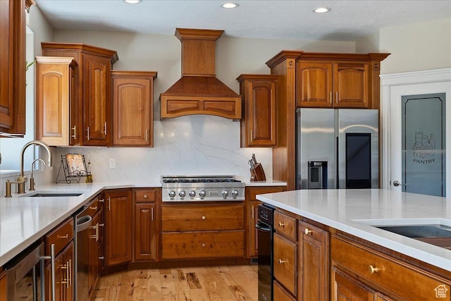 864 S Wellington Dr W, Kaysville, UT 84037 - kitchen with appliances with stainless steel finishes, a sink, premium range hood, beverage cooler, and light countertops