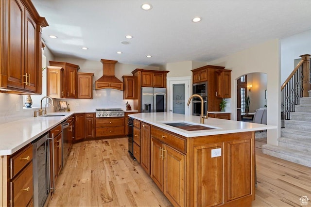 864 S Wellington Dr W, Kaysville, UT 84037 - kitchen featuring appliances with stainless steel finishes, a sink, beverage cooler, custom exhaust hood, and recessed lighting