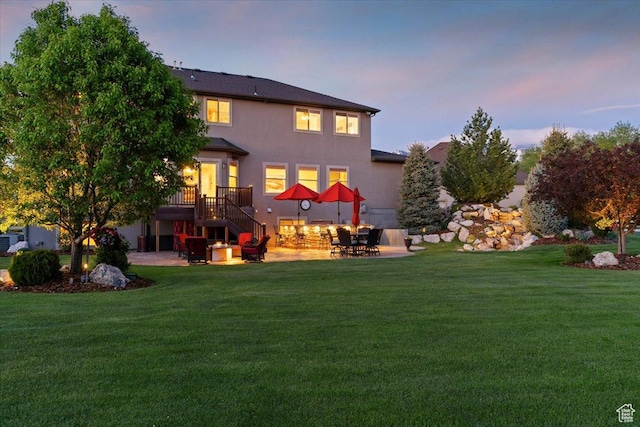 864 S Wellington Dr W, Kaysville, UT 84037 - back of property featuring a patio area, a lawn, and stairway