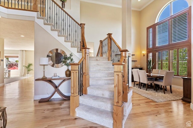 864 S Wellington Dr W, Kaysville, UT 84037 - stairway featuring a towering ceiling, wood finished floors, baseboards, and crown molding