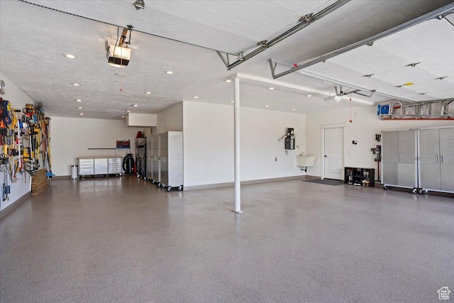 864 S Wellington Dr W, Kaysville, UT 84037 - garage featuring baseboards, recessed lighting, a garage door opener, and a central vacuum unit