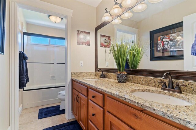 864 S Wellington Dr W, Kaysville, UT 84037 - full bath featuring tile patterned floors, double vanity, toilet, and combined bath / shower with glass door