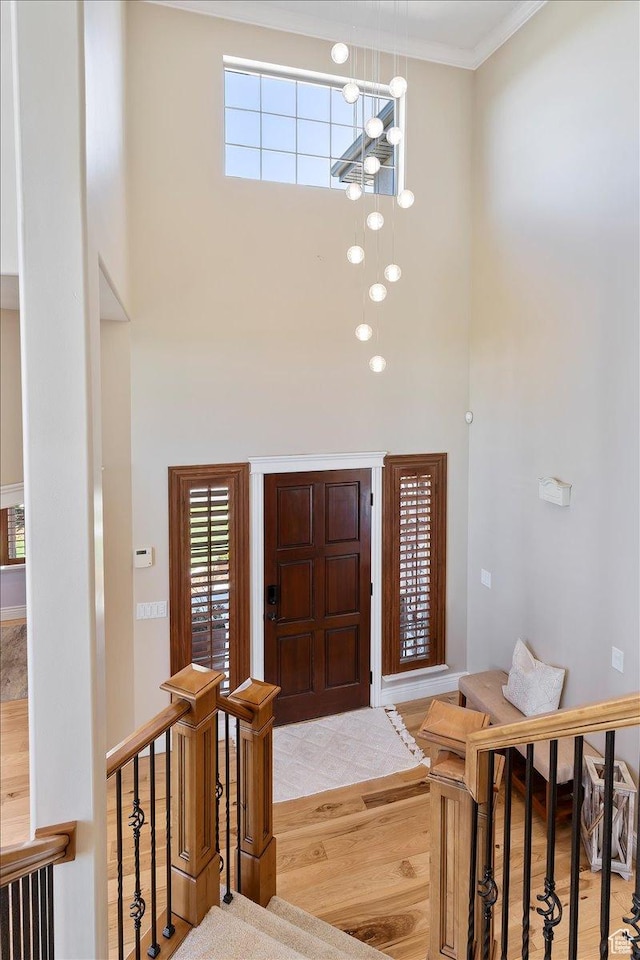864 S Wellington Dr W, Kaysville, UT 84037 - entrance foyer featuring a towering ceiling, a chandelier, wood finished floors, and crown molding