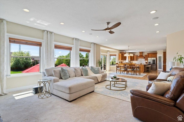 864 S Wellington Dr W, Kaysville, UT 84037 - living room featuring recessed lighting, a ceiling fan, healthy amount of natural light, and light carpet